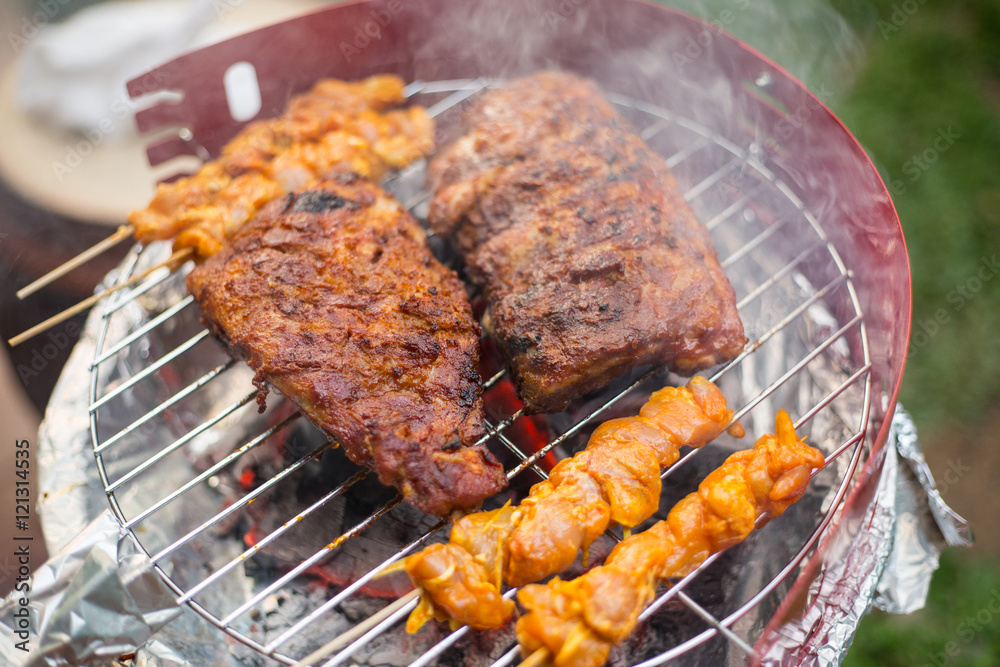 Barbecue grill chicken and pork meat cooking