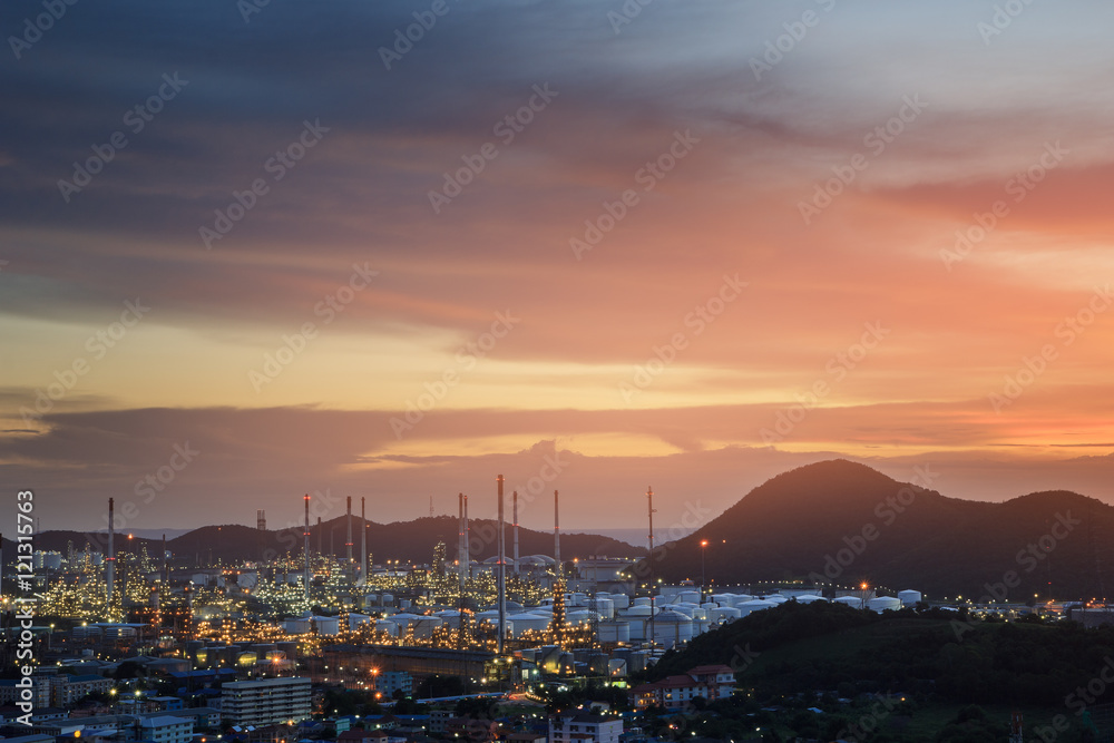 oil refinery with city on beautiful sunset background.