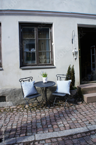  Nice table and chairs with pillows in yard 