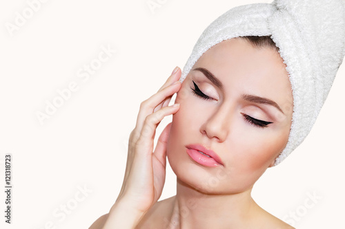 Beautiful natural girl woman after cosmetic procedures , facelift , facial massage , visit a beautician , massage lines. Beautiful woman with a towel on his head. Plastic and cosmetic surgery. 