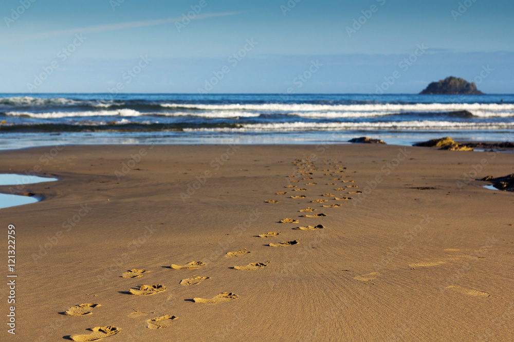 Footprints in the sand on Polzeath beach