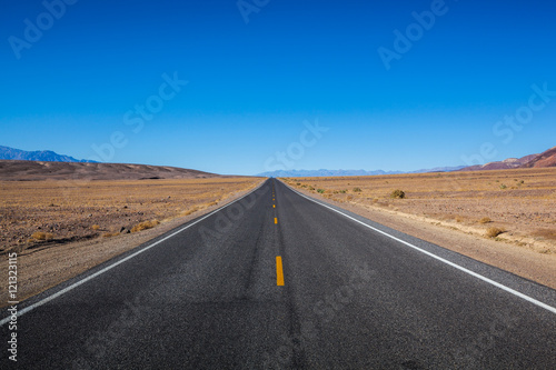 Endless straight road in Death Valley National Park desert
