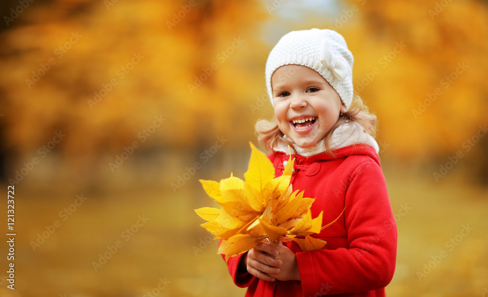 happy child girl laughing with leaves in autumn happy child girl laughing with leaves in autumn