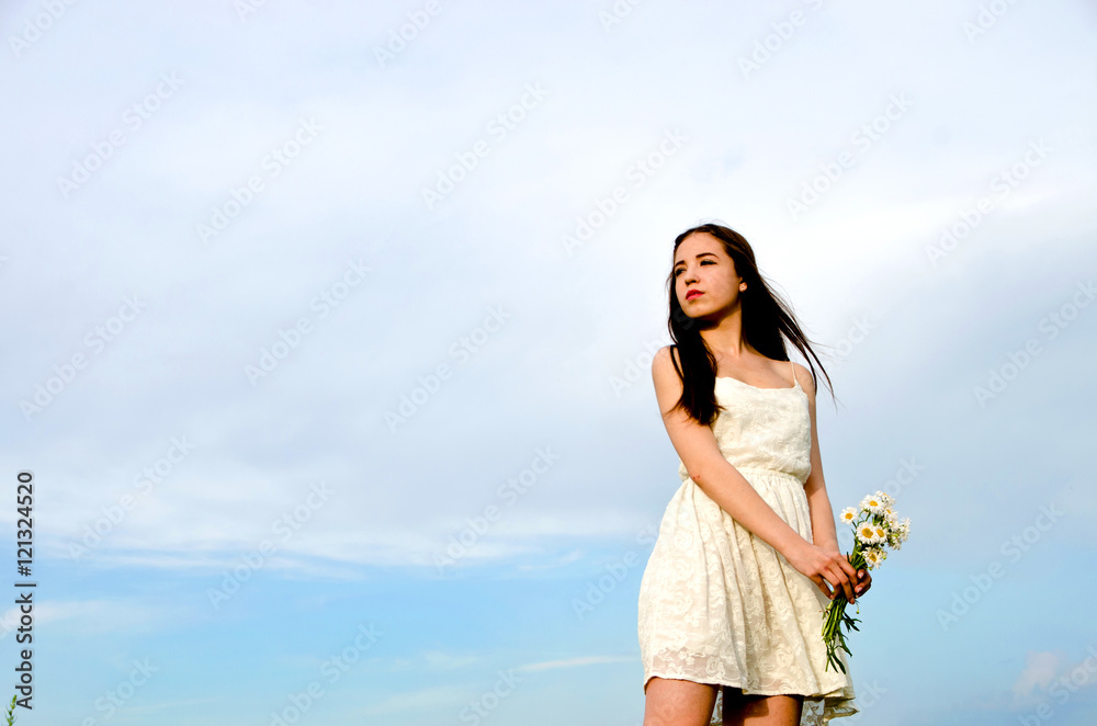 girl in a white dress with a flower girl in a white dress with a flower