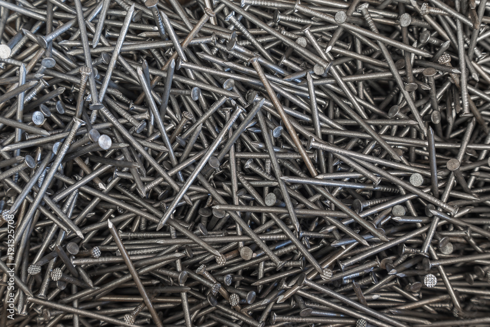 Industrial background of multiple nails stored in a box. closeup. Tools series. Industrial background of multiple nails stored in a box. closeup. Tools series.