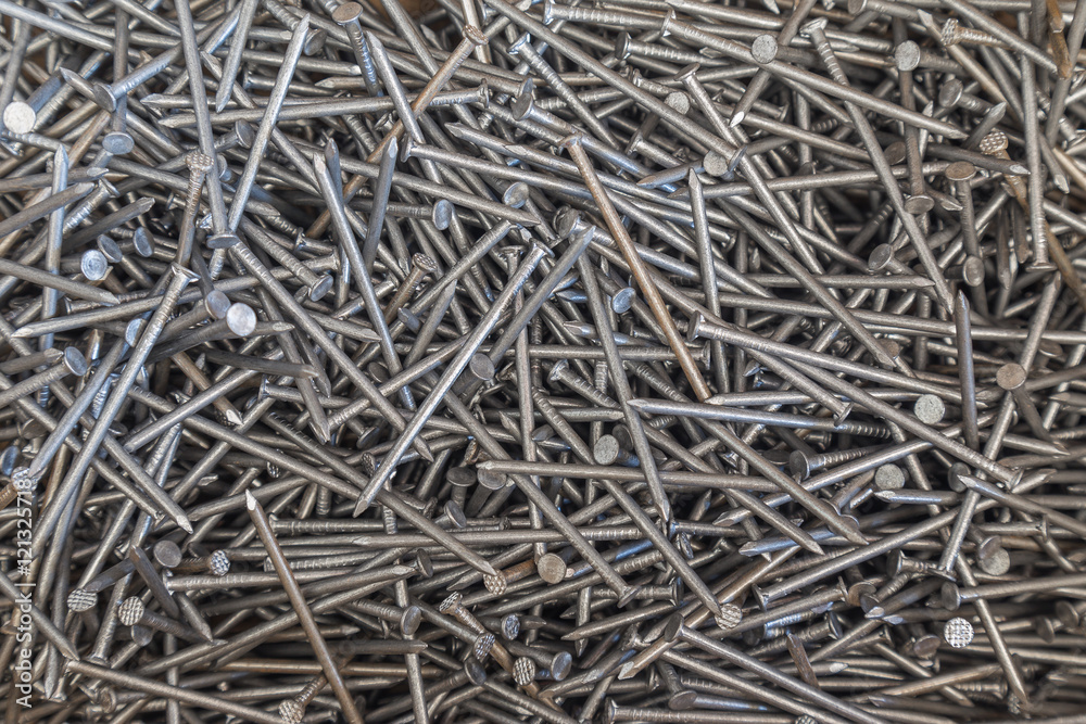 Industrial background of multiple nails stored in a box. closeup. Tools series. Industrial background of multiple nails stored in a box. closeup. Tools series.