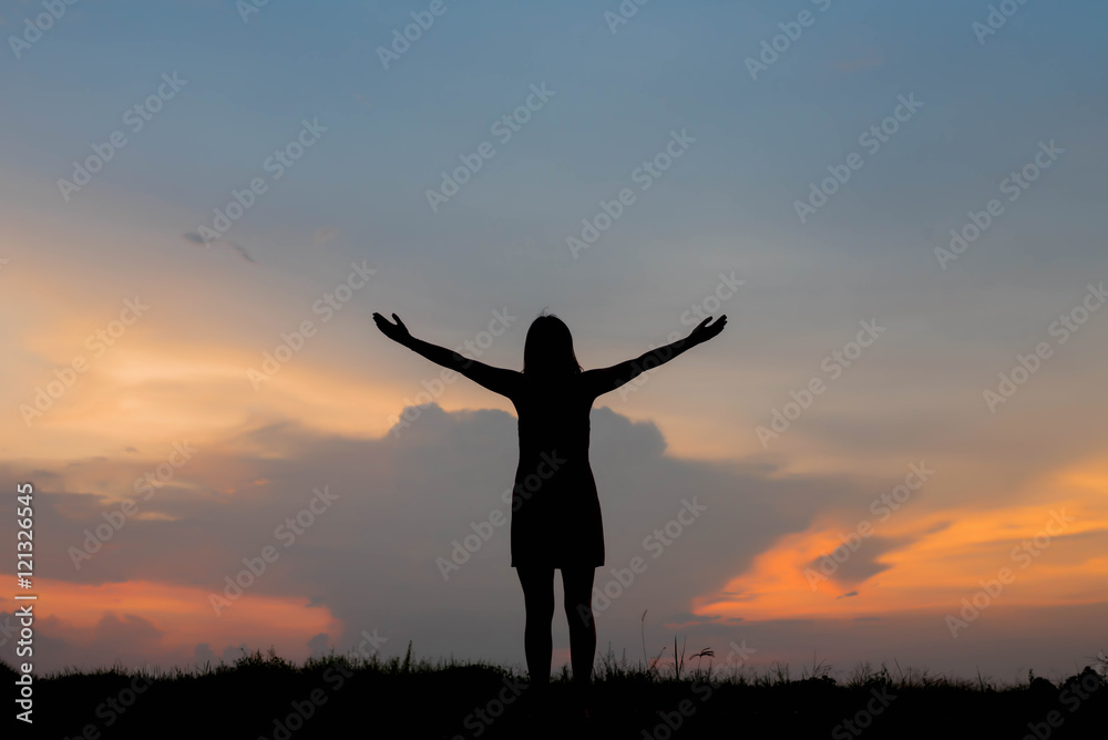 silhouette of woman happy alone at  sunset
