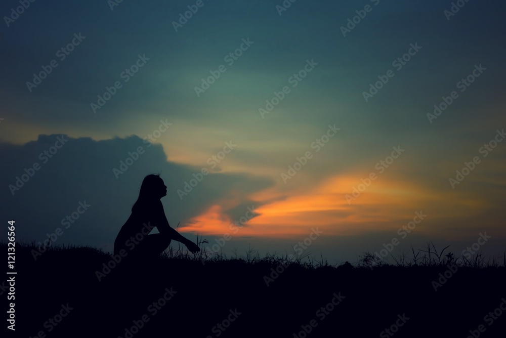 silhouette of woman Looking for a dream at sunset
