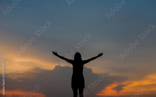 silhouette of woman happy alone at sunset