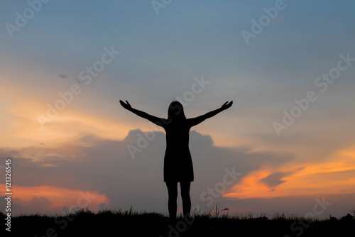 silhouette of woman happy alone at  sunset © stcom