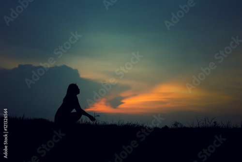 silhouette of woman Looking for a dream at sunset