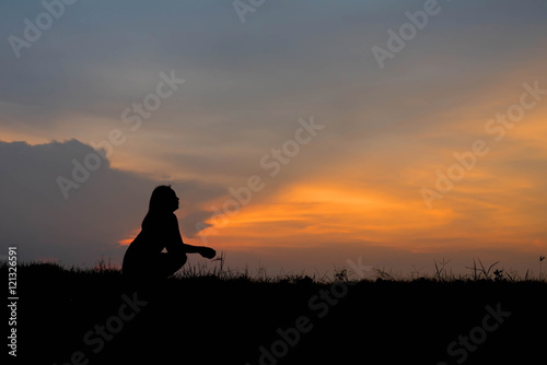 silhouette of woman Looking for a dream at sunset