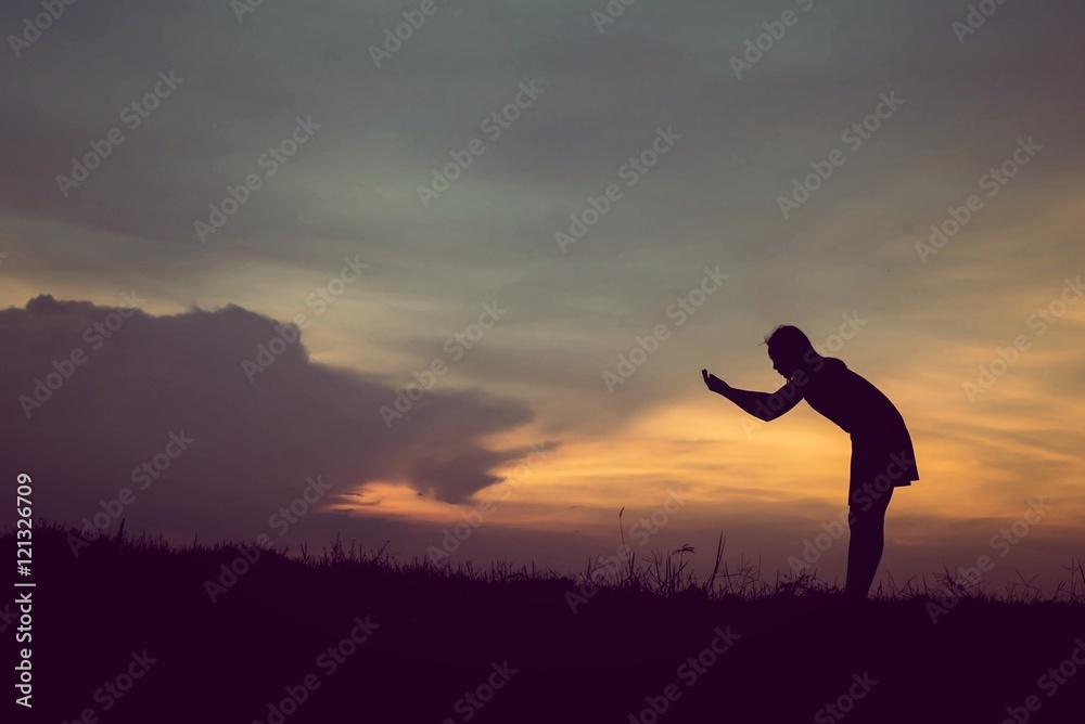 silhouette of woman Standing blessings of god at sunset silhouette of woman Standing blessings of god at sunset