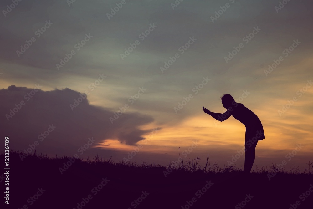 silhouette of woman Standing blessings of god at sunset