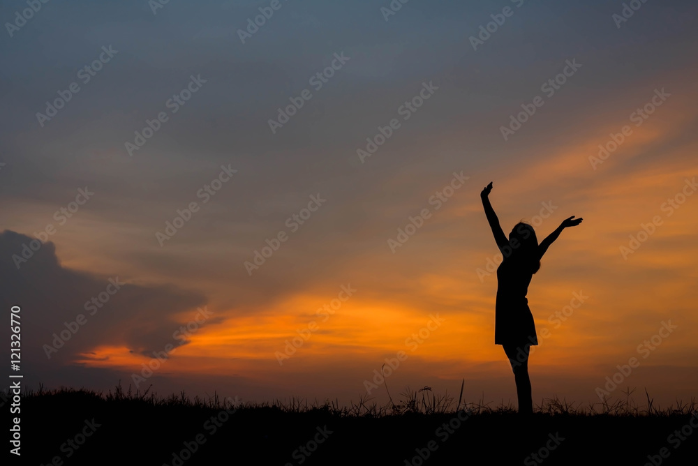 silhouette of woman  enjoys outdoor at sunset