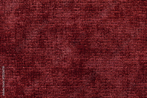 Dark red background from soft textile material. Fabric with natural texture.