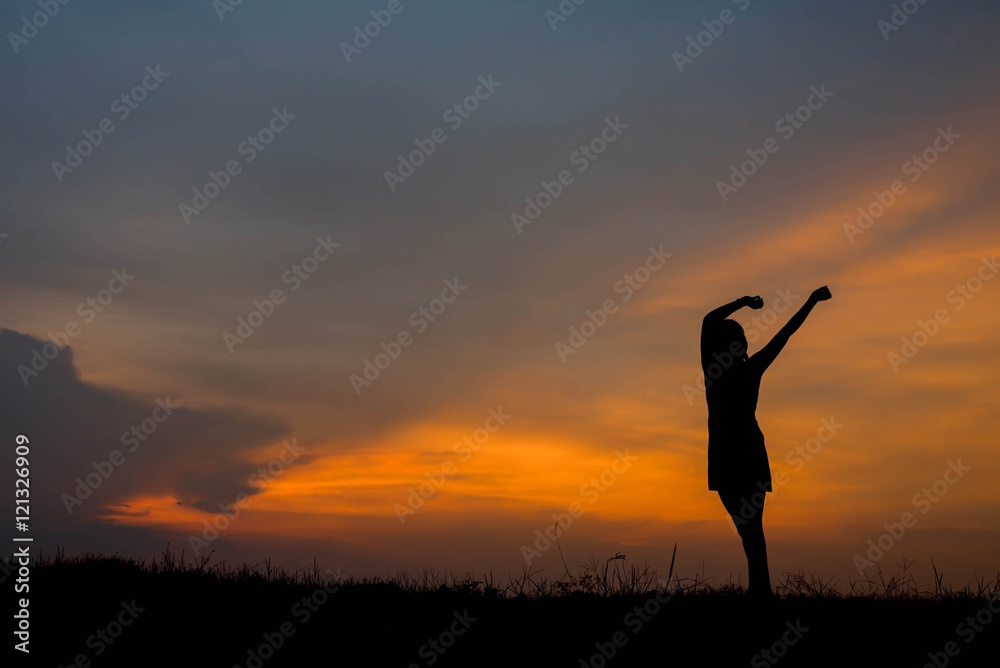 silhouette of woman  enjoys outdoor at sunset