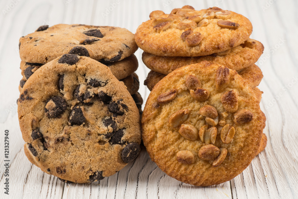 Biscuits with chocolate and peanut on old wooden table. Biscuits with chocolate and peanut on old wooden table.