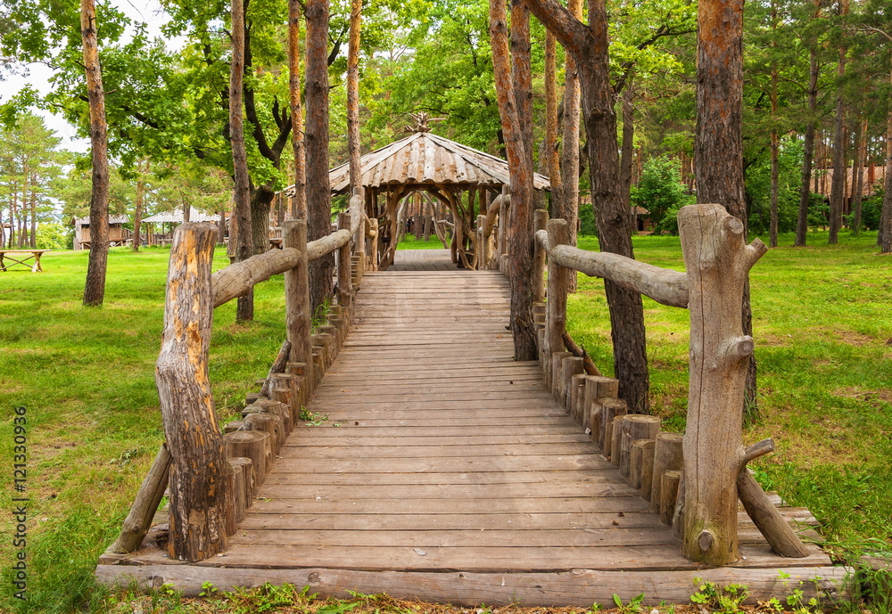 Wooden house with a bridge in the forest