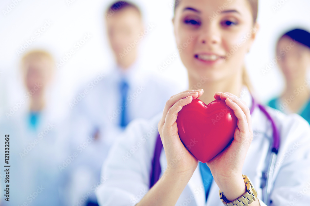 Female doctor with stethoscope holding heart Female doctor with stethoscope holding heart
