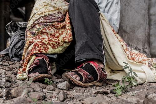 Close-up shooting of homeless woman’s shoes photo