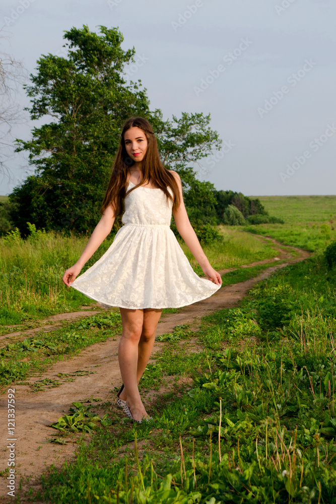 girl in a dress walking in a field