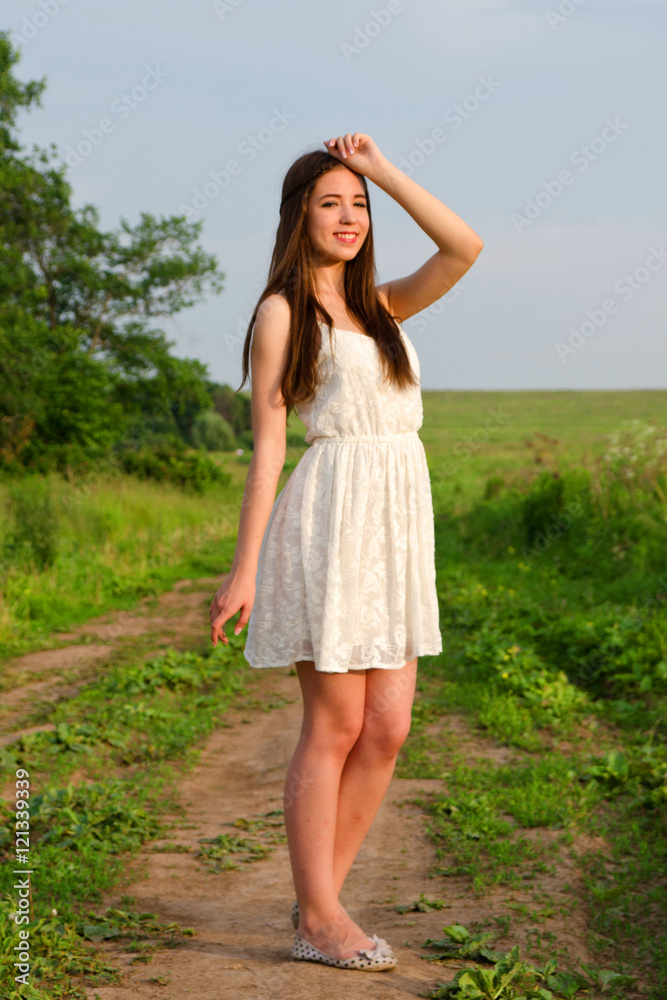 girl in white dress on the footpath girl in white dress on the footpath