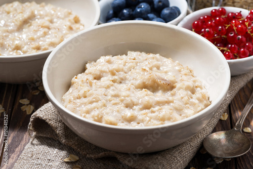 homemade oatmeal and berries on wooden table, closeup