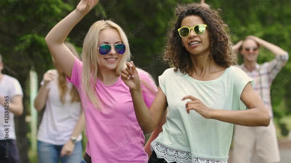 Summertime, two best female friends dancing at party, young people having fun Summertime, two best female friends dancing at party, young people having fun