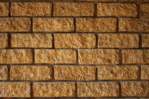 Decorative ocher brick wall on a house exterior