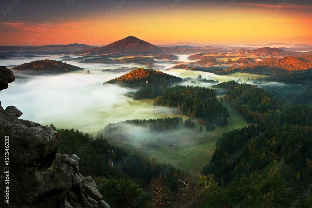 Czech typical autumn landscape. Hills and villages with foggy morning. Morning fall valley of Bohemian Switzerland park. Hills with fog, landscape of Czech Republic, landscape from Ceske Svycarsko. 