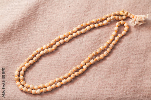 Traditional Indian japa mala chanting beads on woolen texture
