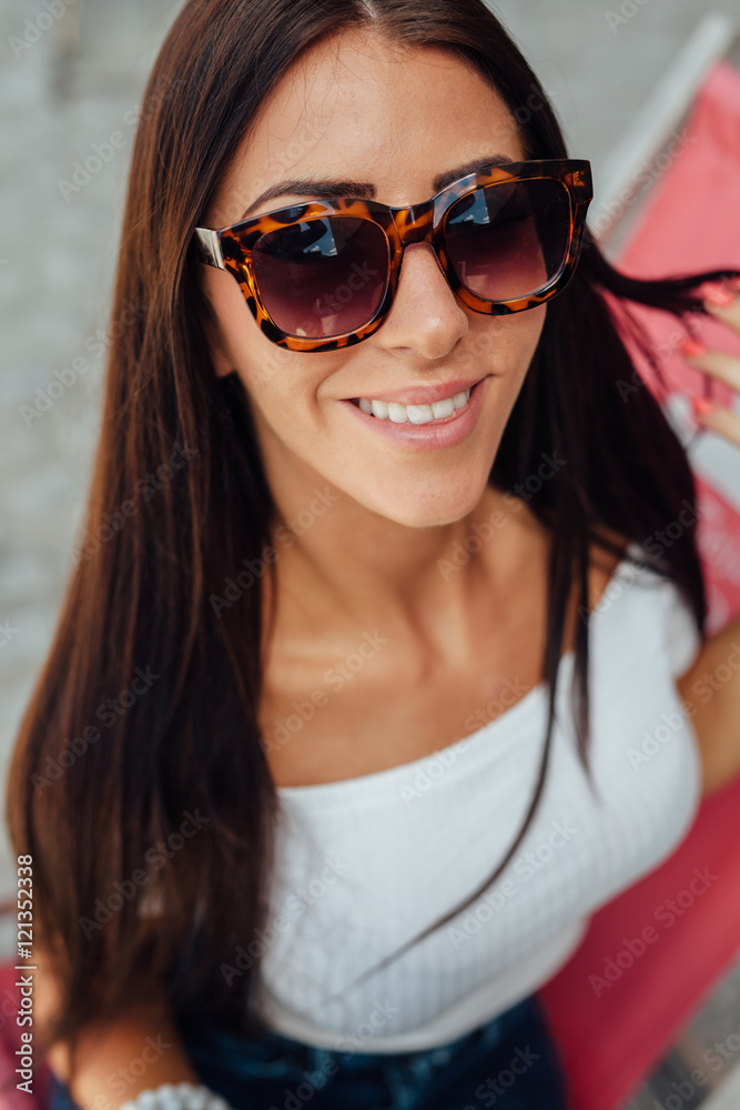 Portrait of a happy young girl wearing sunglasses. Portrait of a happy young girl wearing sunglasses.