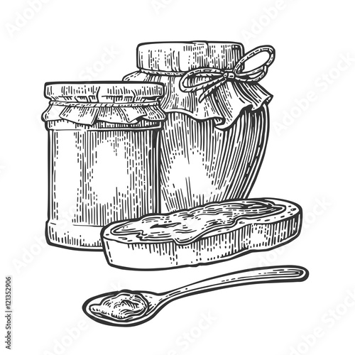 Jar, spoon and slice of bread with jam.
