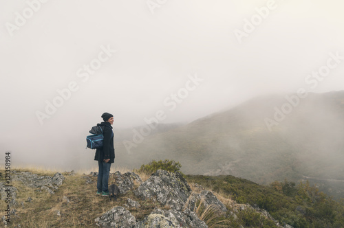 Woman hiking on a cloudy autumn day