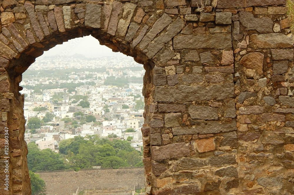 View of Hyderabad through stone arch from Golconda fort, a heritage and land mark built in 1600's in Telangana,India