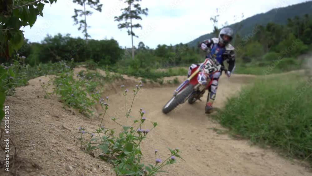 Motorcross biker driving motorcycle offroad Motorcross biker driving motorcycle offroad