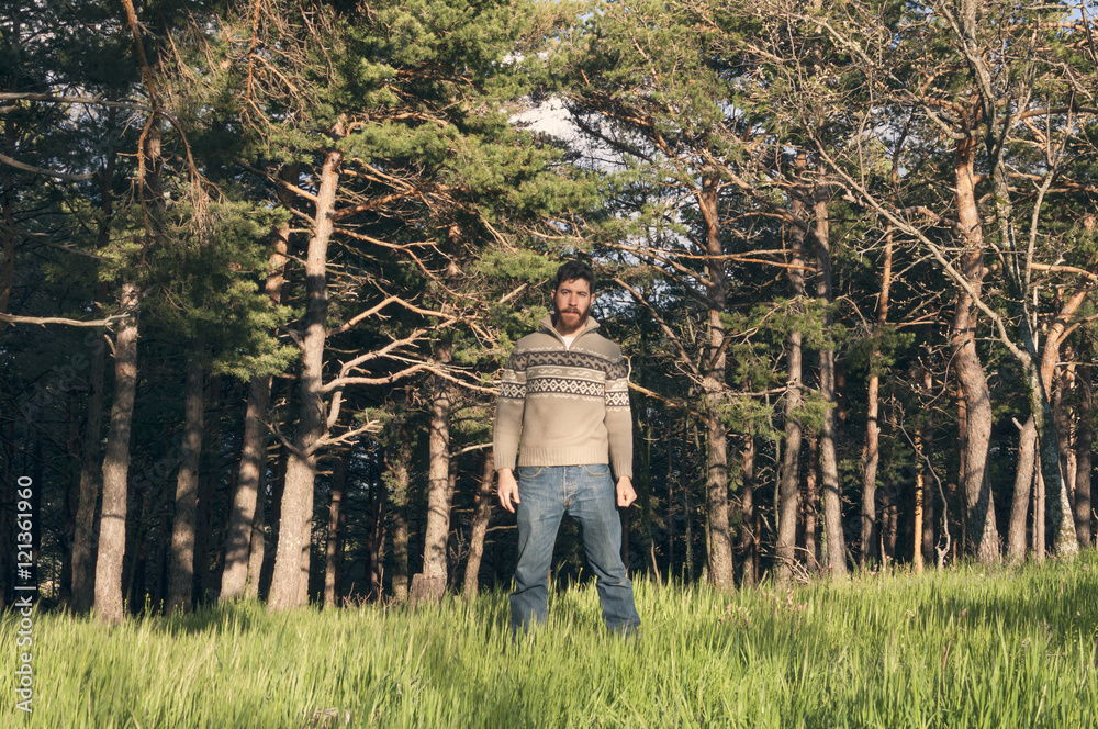Young man in the woods enjoying a sunny afternoon Young man in the woods enjoying a sunny afternoon