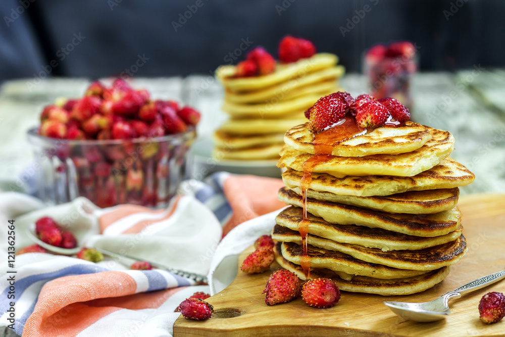 Pancakes with fresh strawberry and jam on white wooden background Pancakes with fresh strawberry and jam on white wooden background