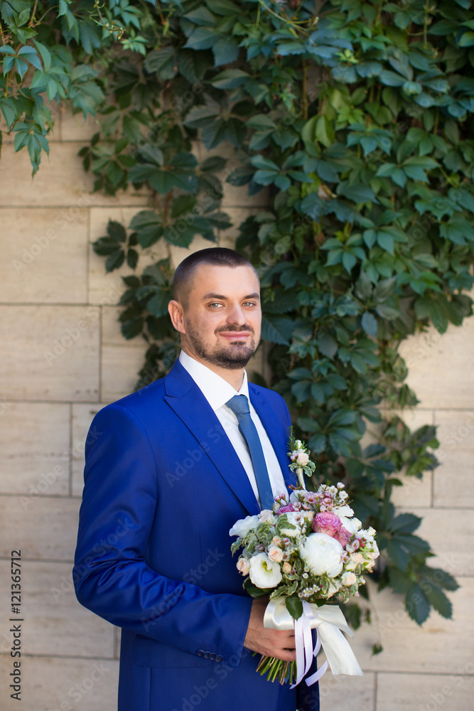 The groom in a stylish blue suit The groom in a stylish blue suit