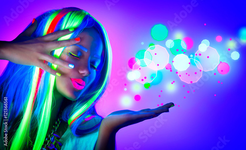 Fashion woman in neon light. Beautiful model girl with fluorescent make-up