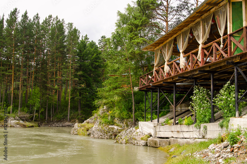 River Katun in Altai mountains, wooden terrace above river, beautiful forest River Katun in Altai mountains, wooden terrace above river, beautiful forest