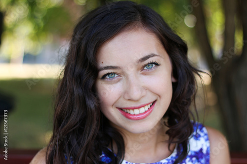 Portrait of sexual young woman sitting in the Park