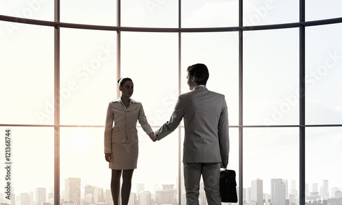 Business partners handshake . Mixed media © Sergey Nivens