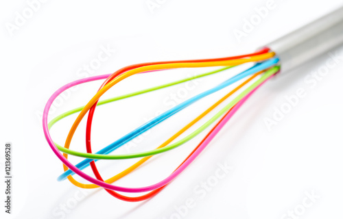 Colored plastic french whisk isolated on white background