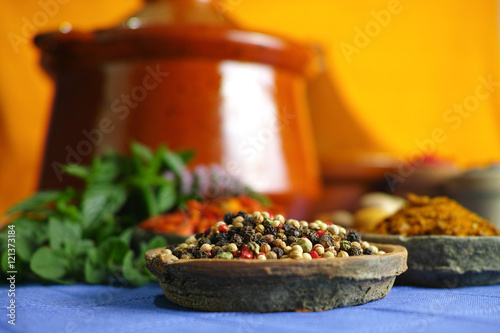 Collection of different spices in old clay bowls in colorful oriental style photo