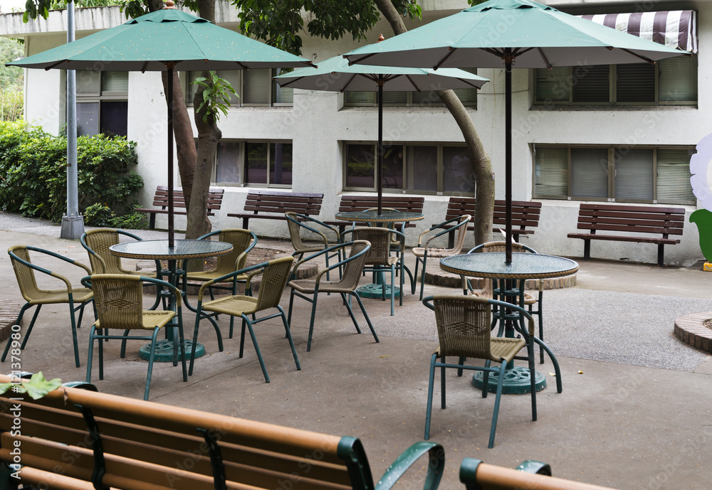 Street view of a coffee terrace with tables and chairs