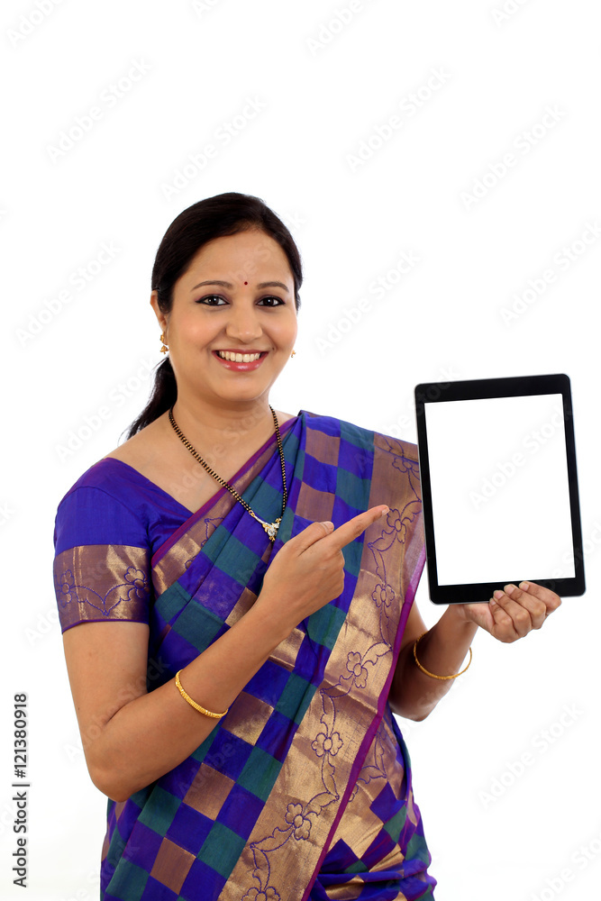 Traditional Indian woman using a tablet computer Traditional Indian woman using a tablet computer