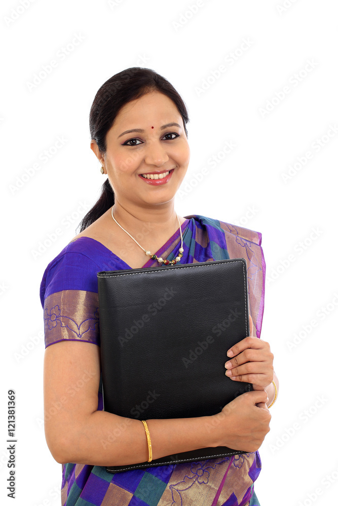 Happy traditional woman holding folder against white background Happy traditional woman holding folder against white background