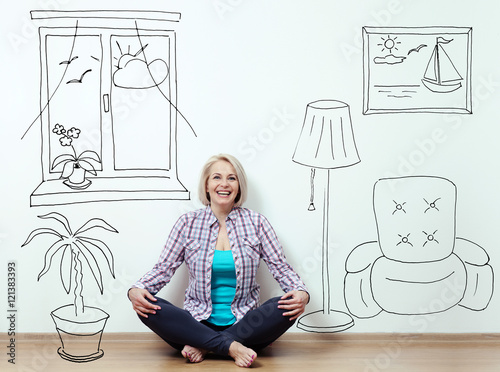 Quadro su tela Happy woman sitting on the floor with crossed legs in fashionable clothing on wh